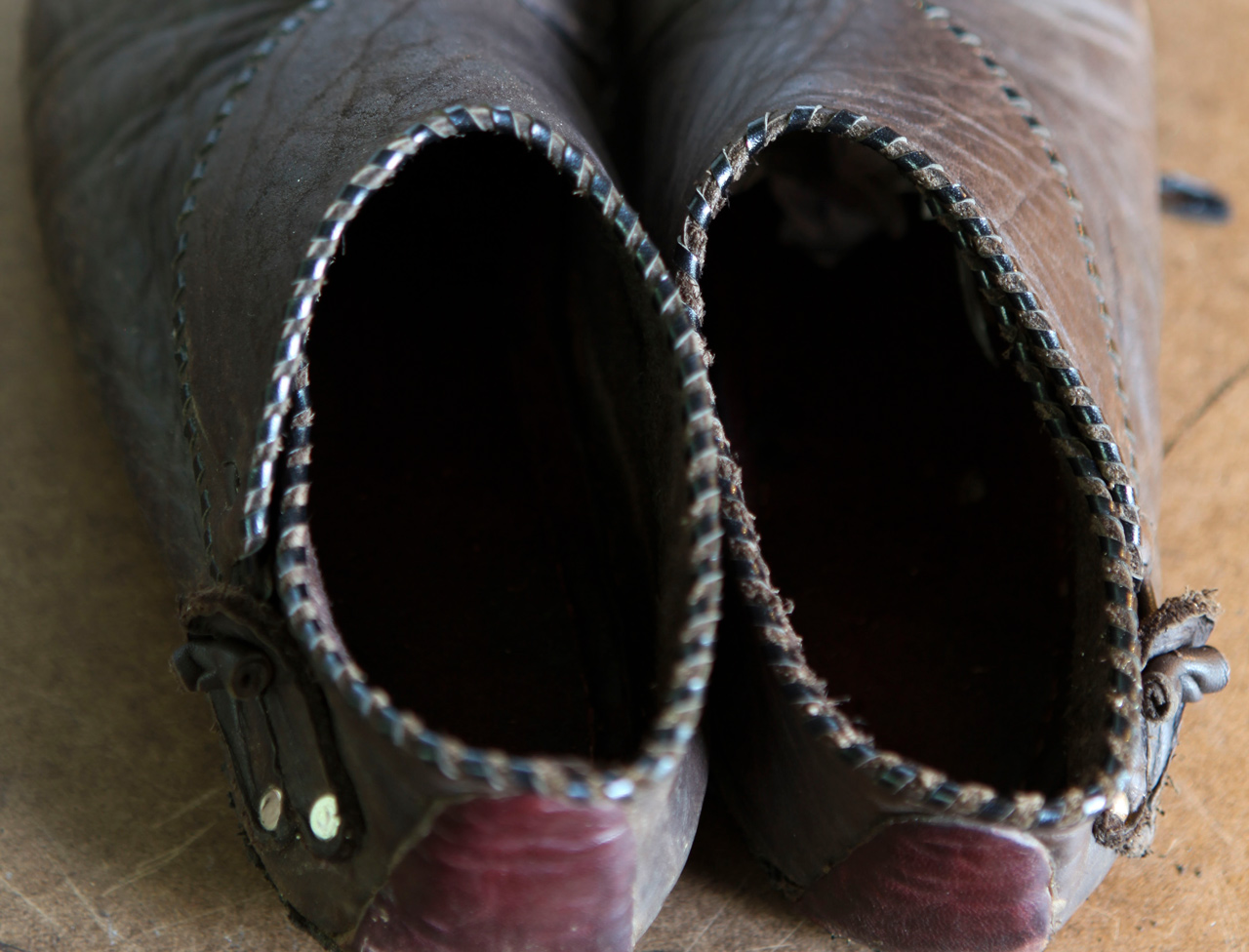 Closeup of whip stitching on a well worn pair of handmade shoes
